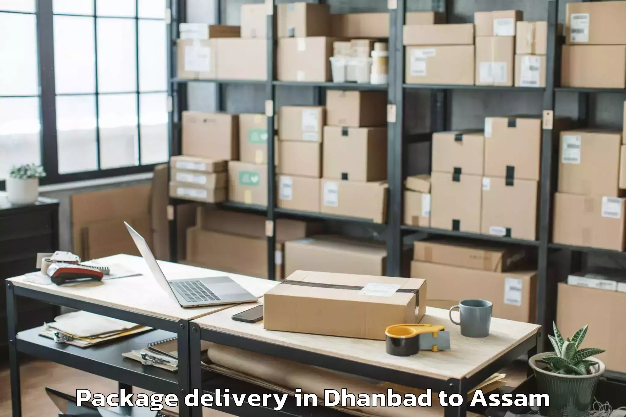 Dhanbad to Lalapur Hailakandi Package Delivery